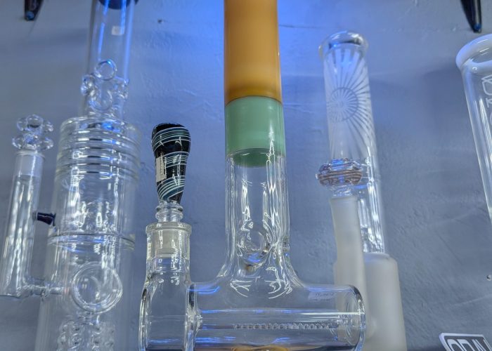 Clear glass percolator bongs displayed in retail store.