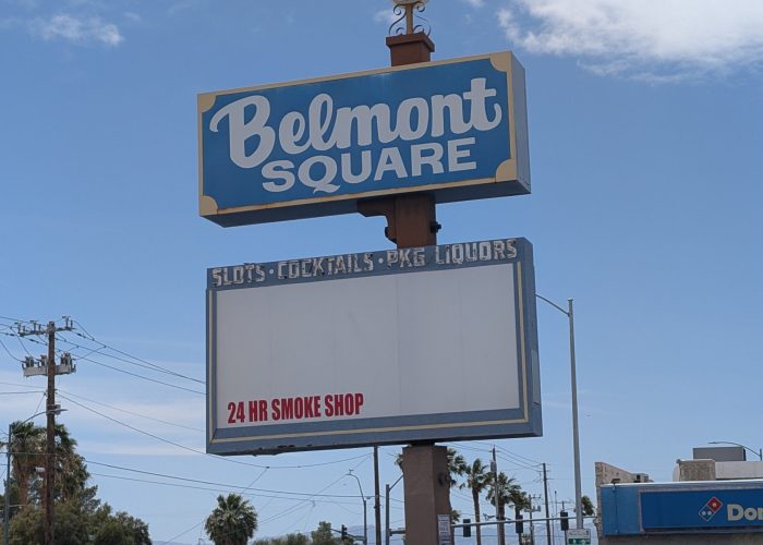 Daytime photograph of Belmont Square retail plaza sign