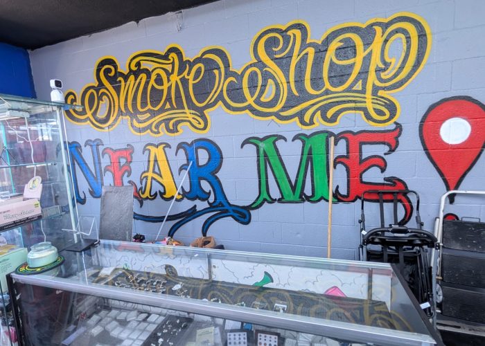Colorful painted wall mural behind glass display cases